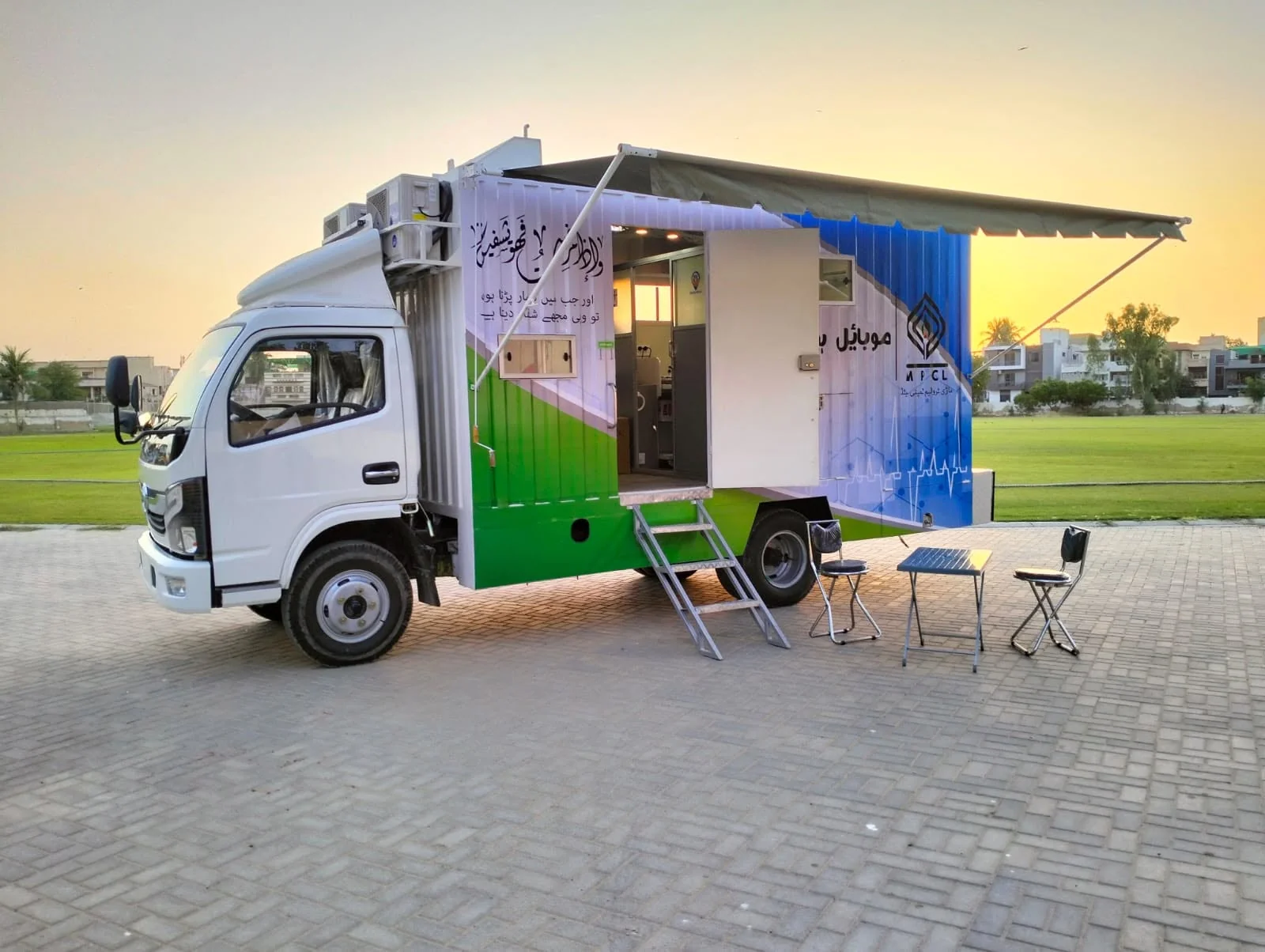 Truck-mounted mobile facility with an open side entrance and awning